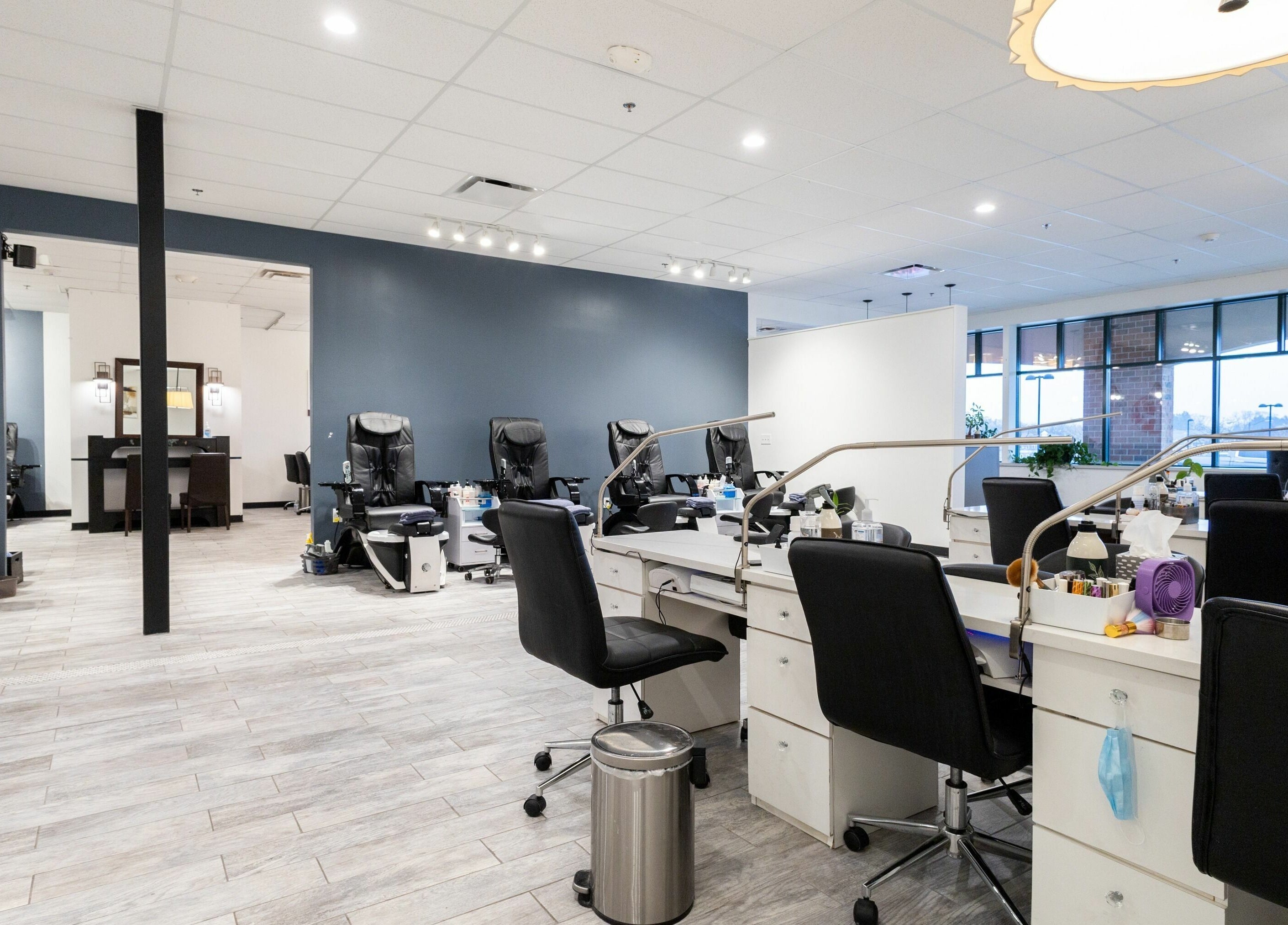 Ruby Nails salon in Brookfield, Wisconsin, US features modern manicure stations with sleek black chairs.