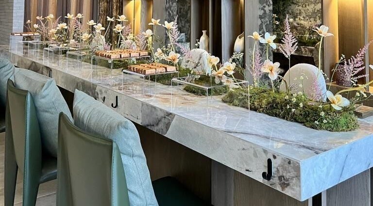 Elegant floral arrangement on marble counter at Tones Beauty, Jeddah, Makkah Province, SA.