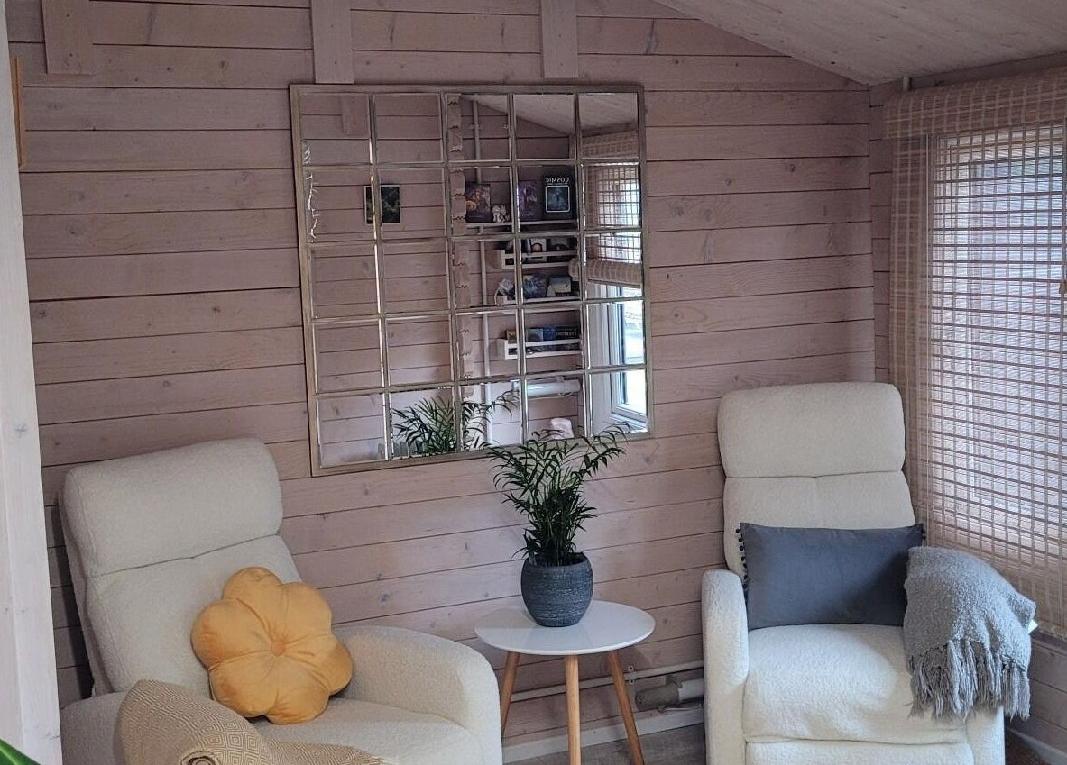 Tranquil lounge area at Holistic Healing & Wellbeing, Peterborough, England, GB with comfy chairs and plants.
