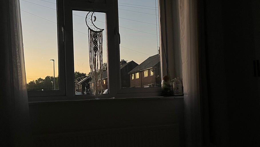Tranquil sunset through window with dreamcatcher at beautified by ella, Preston, England, GB.