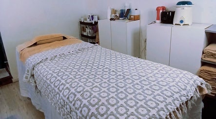 Cozy treatment room at Authentically You Emporium, Cape Town, Western Cape, ZA, featuring a massage bed.
