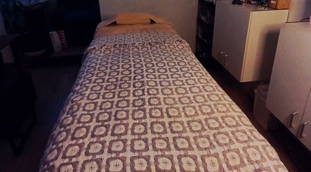 Tranquil massage room with a patterned bed at Authentically You Emporium, Cape Town, Western Cape, ZA.