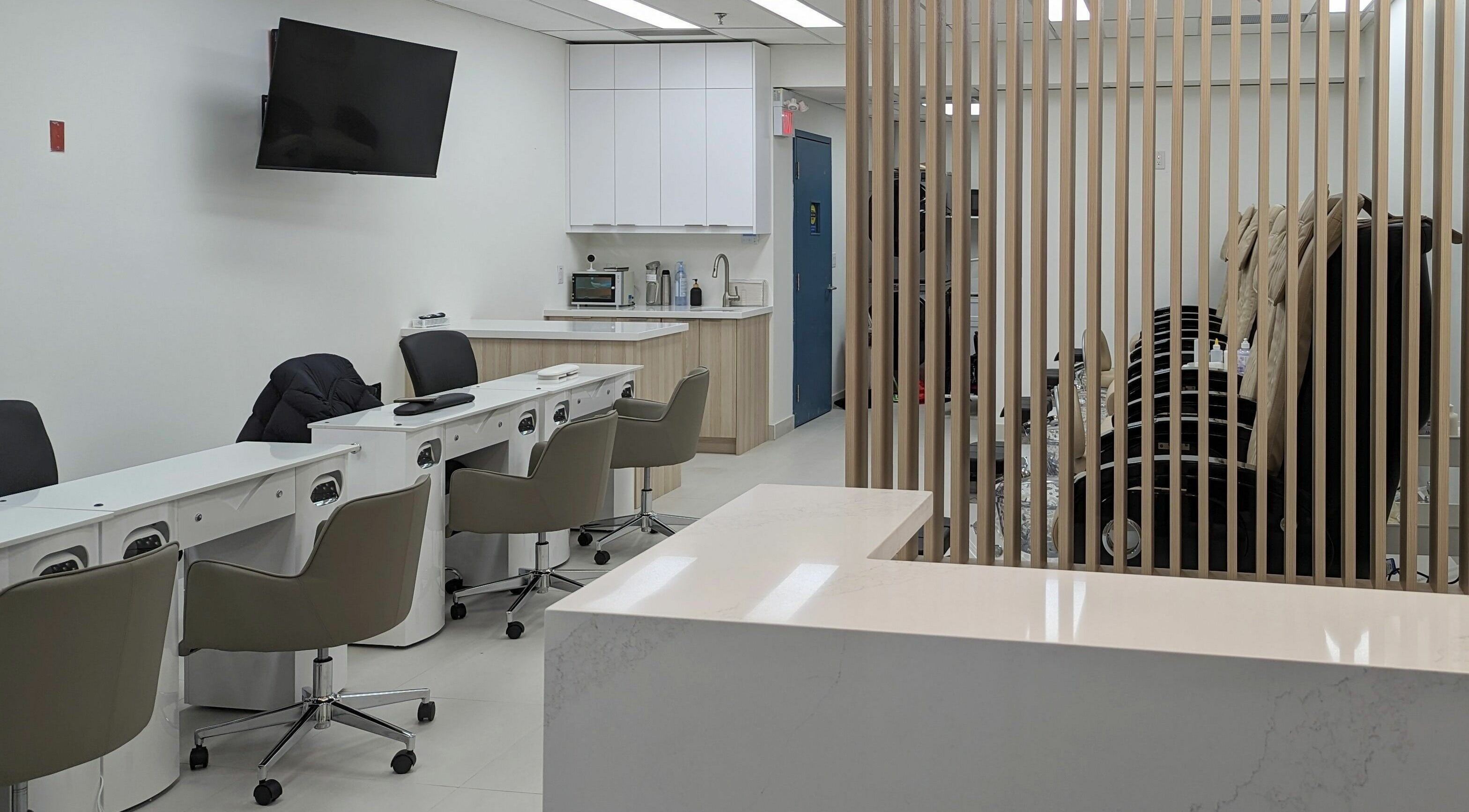 Sleek interior of Elle Nail Bar Toronto, Ontario, CA showcasing contemporary chairs and manicure stations.