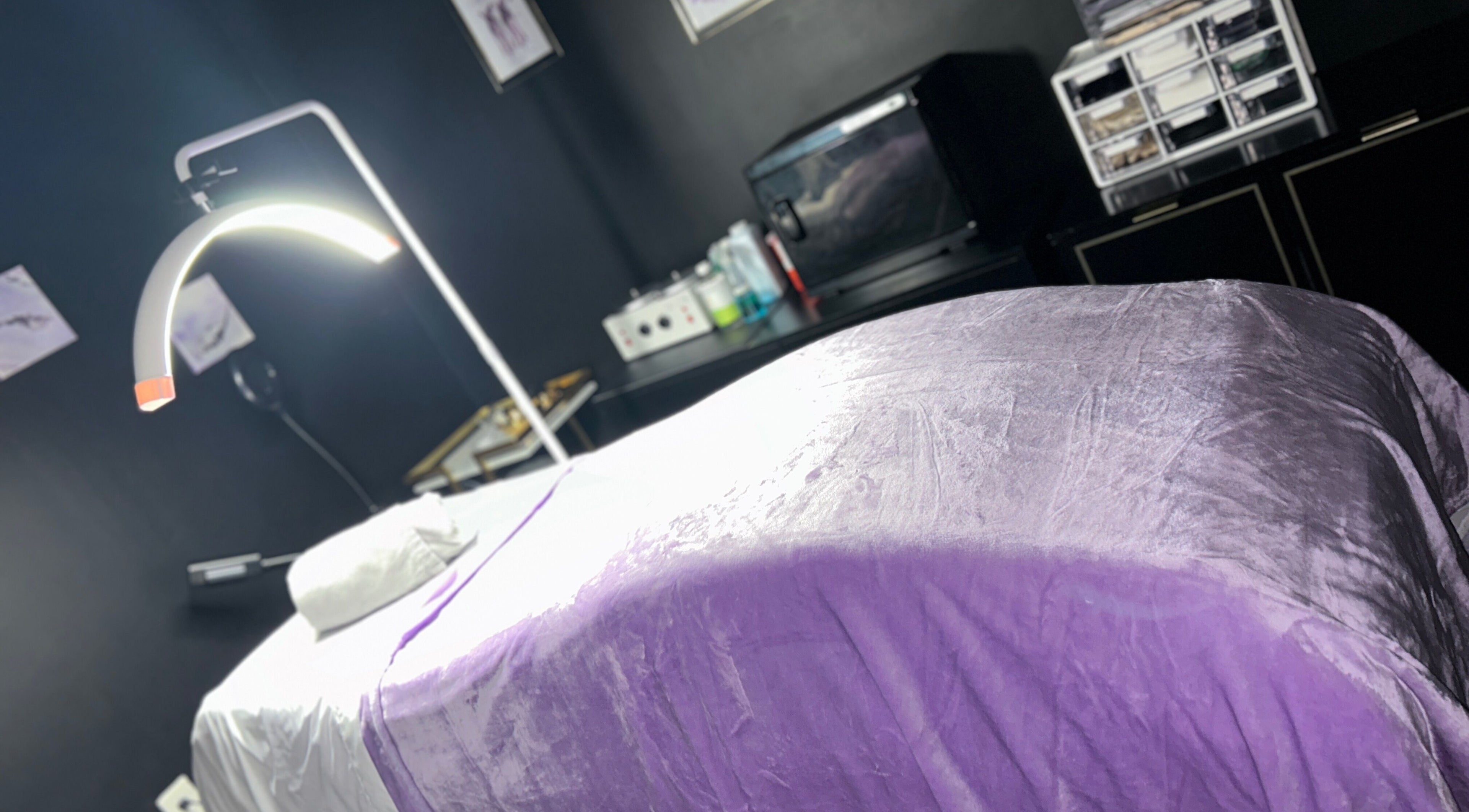 Cozy treatment room at Nail Doctor Unblemished in Maplewood, Missouri, US, with a plush lavender treatment table.