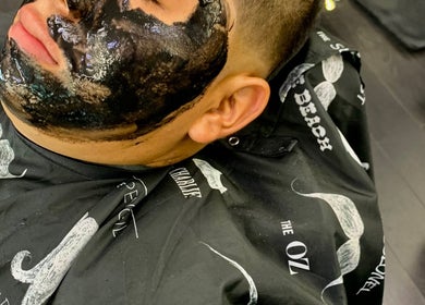 Client receiving a charcoal facial mask at Rayzor Crisp Cutz in Los Angeles, California, US.