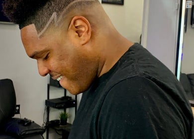 Man with stylish fade haircut at Rayzor Crisp Cutz in Los Angeles, California, US.