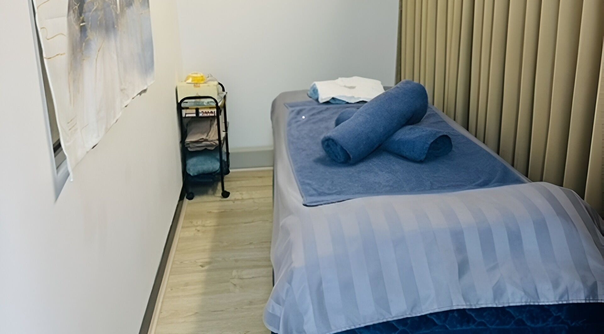 Massage room at Remedial Massage Riverton in Parkwood, Western Australia, AU with a neatly made therapy bed.