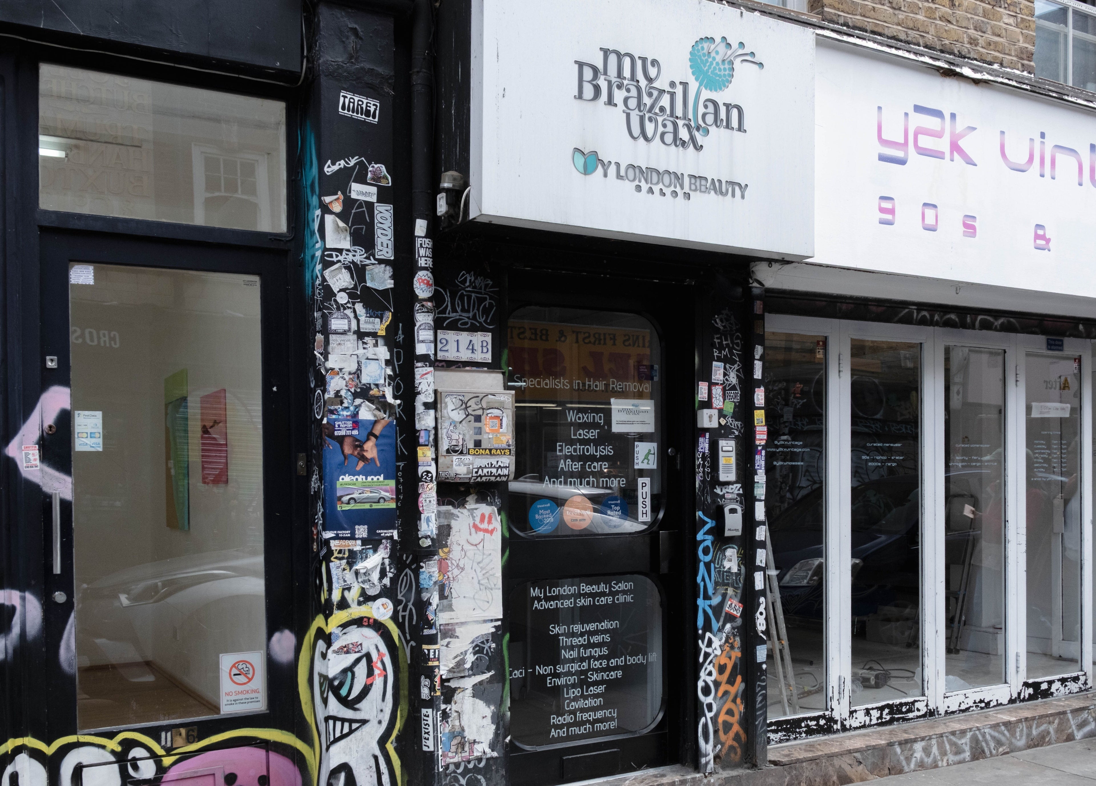 Entrance of My Brazilian Wax, a chic beauty salon in London, England, GB with vibrant street art on the facade.