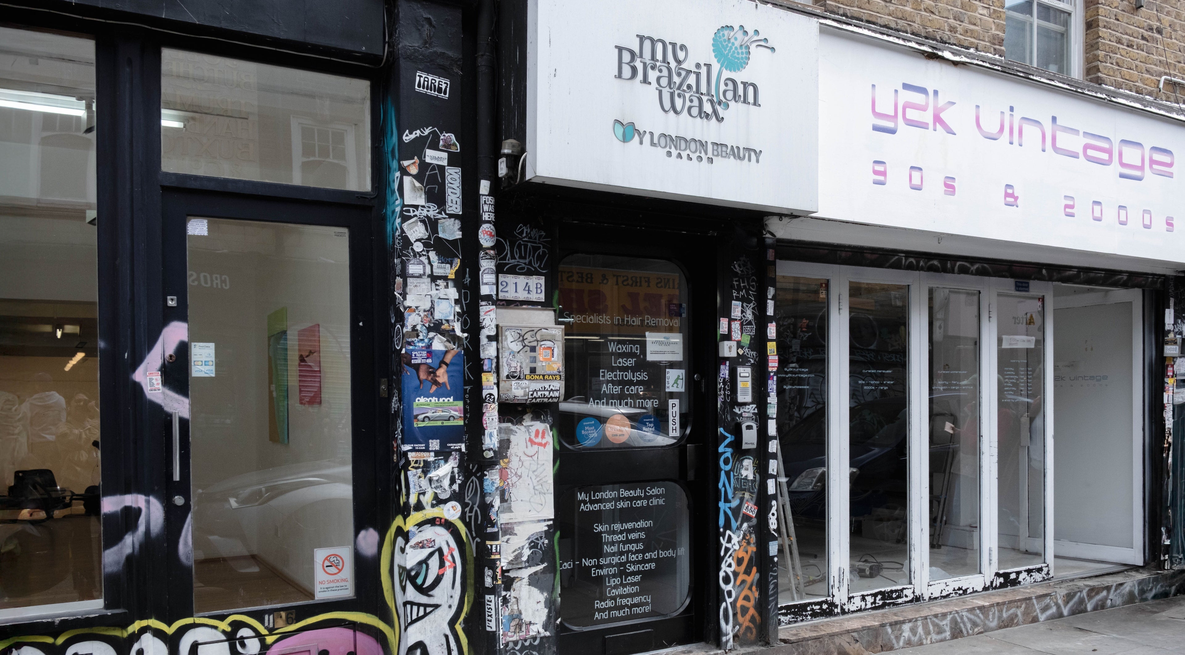 Entrance of My Brazilian Wax, a chic beauty salon in London, England, GB with vibrant street art on the facade.