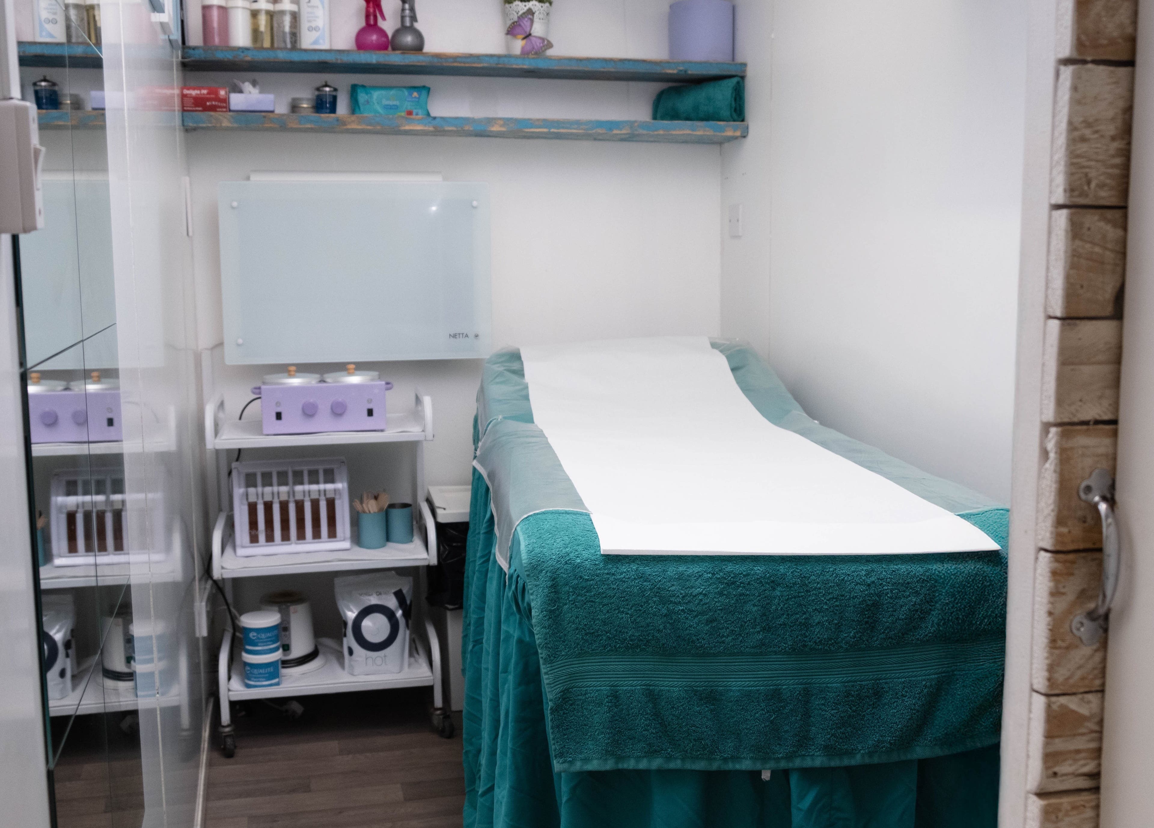 Cozy waxing room at My Brazilian Wax, London, England, GB, featuring a neatly prepared treatment bed.