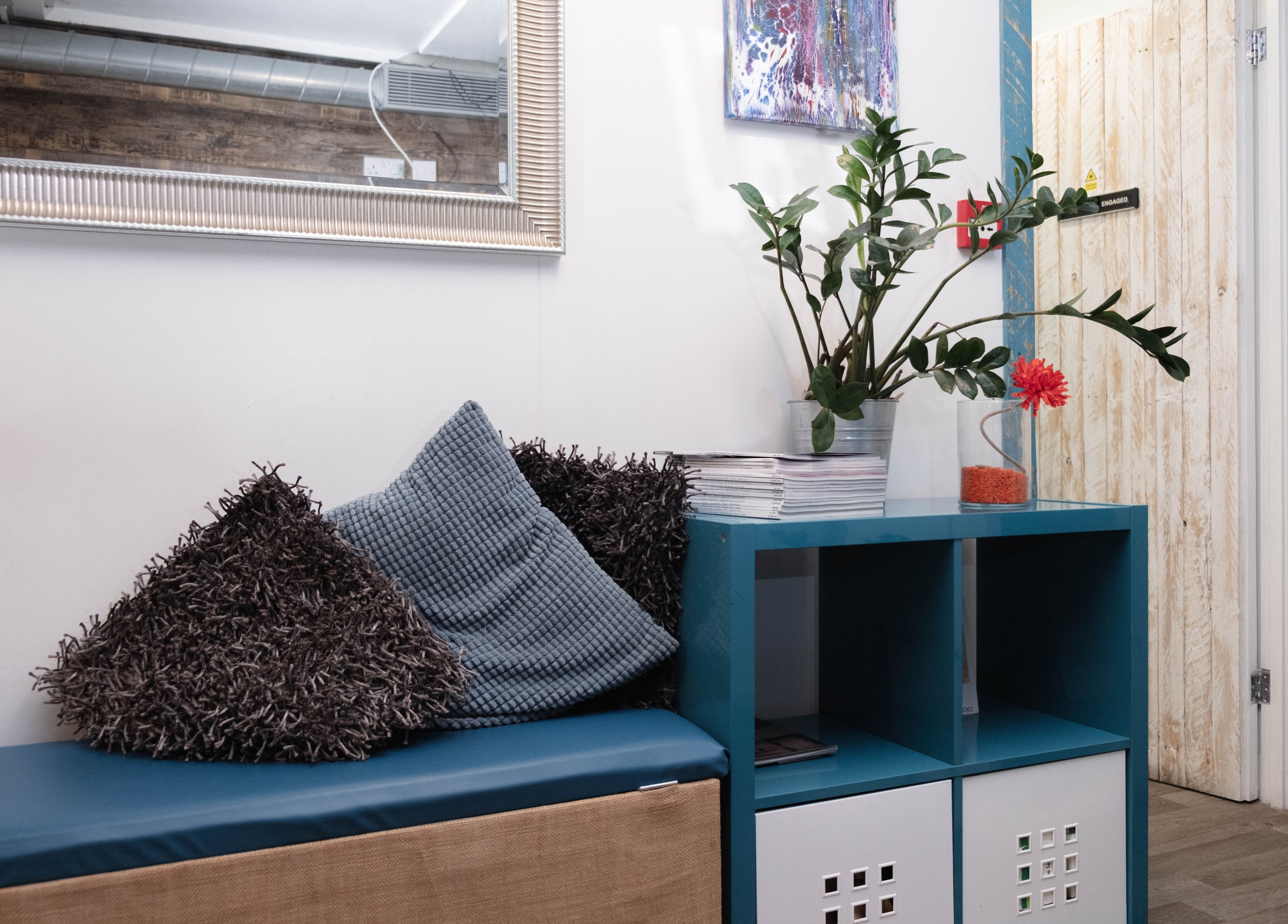 Comfortable seating area in My Brazilian Wax, featuring cushions and modern decor in London, England, GB.