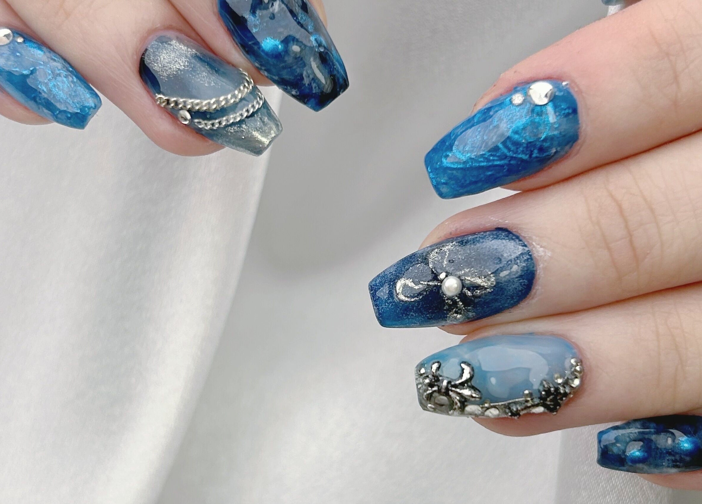 Elegant blue nails with decorative gems at the Nail Room, 香港島, 香港島, HK.