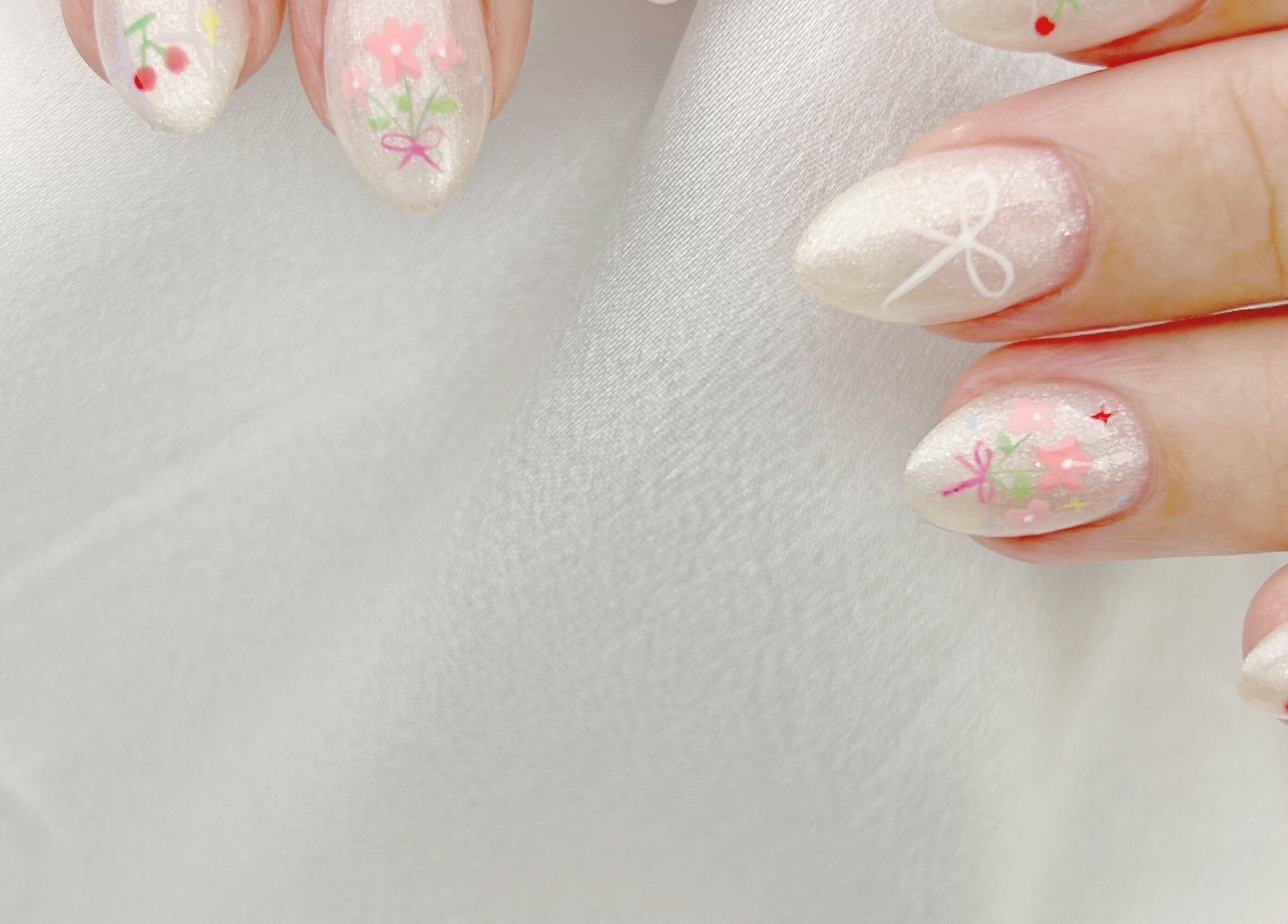 Elegant floral nail art at Nail Room, 香港島, 香港島, HK. Pastel designs on glossy white nails.