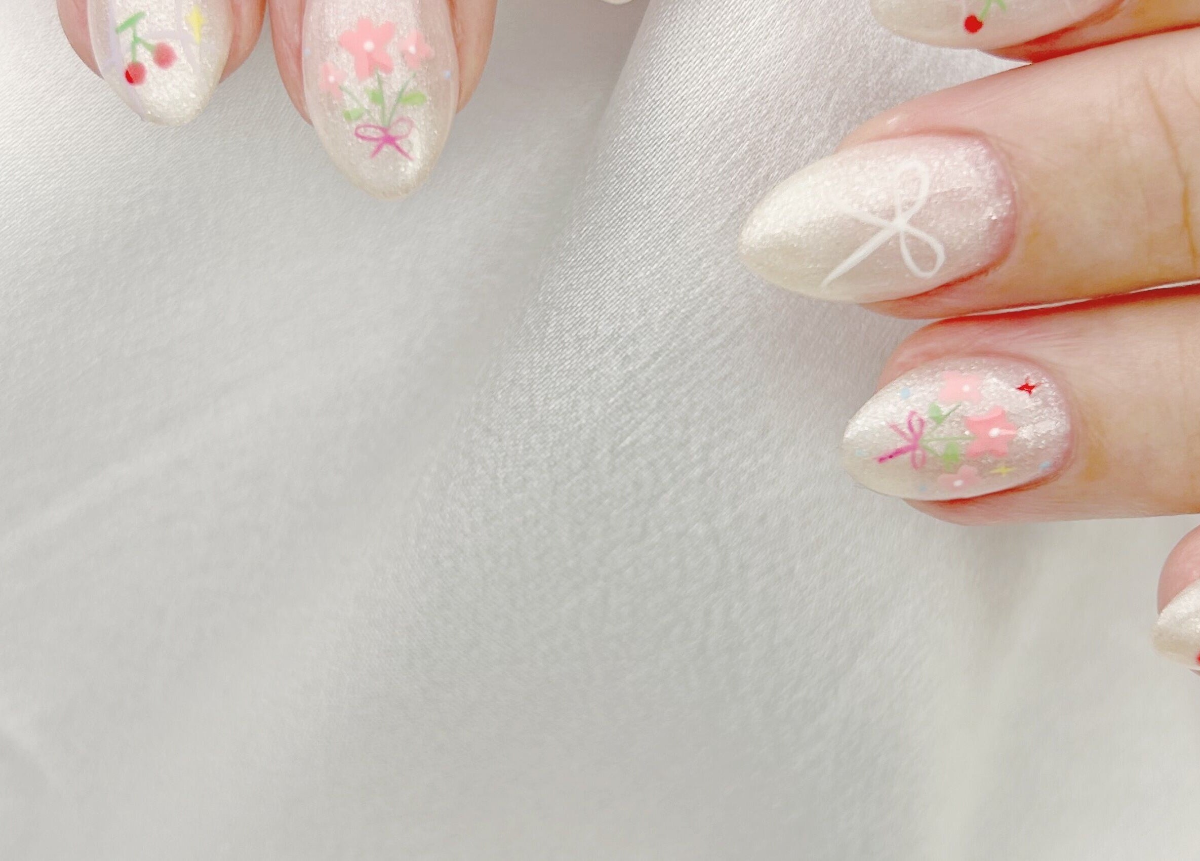 Elegant floral nail art at Nail Room, 香港島, 香港島, HK. Pastel designs on glossy white nails.