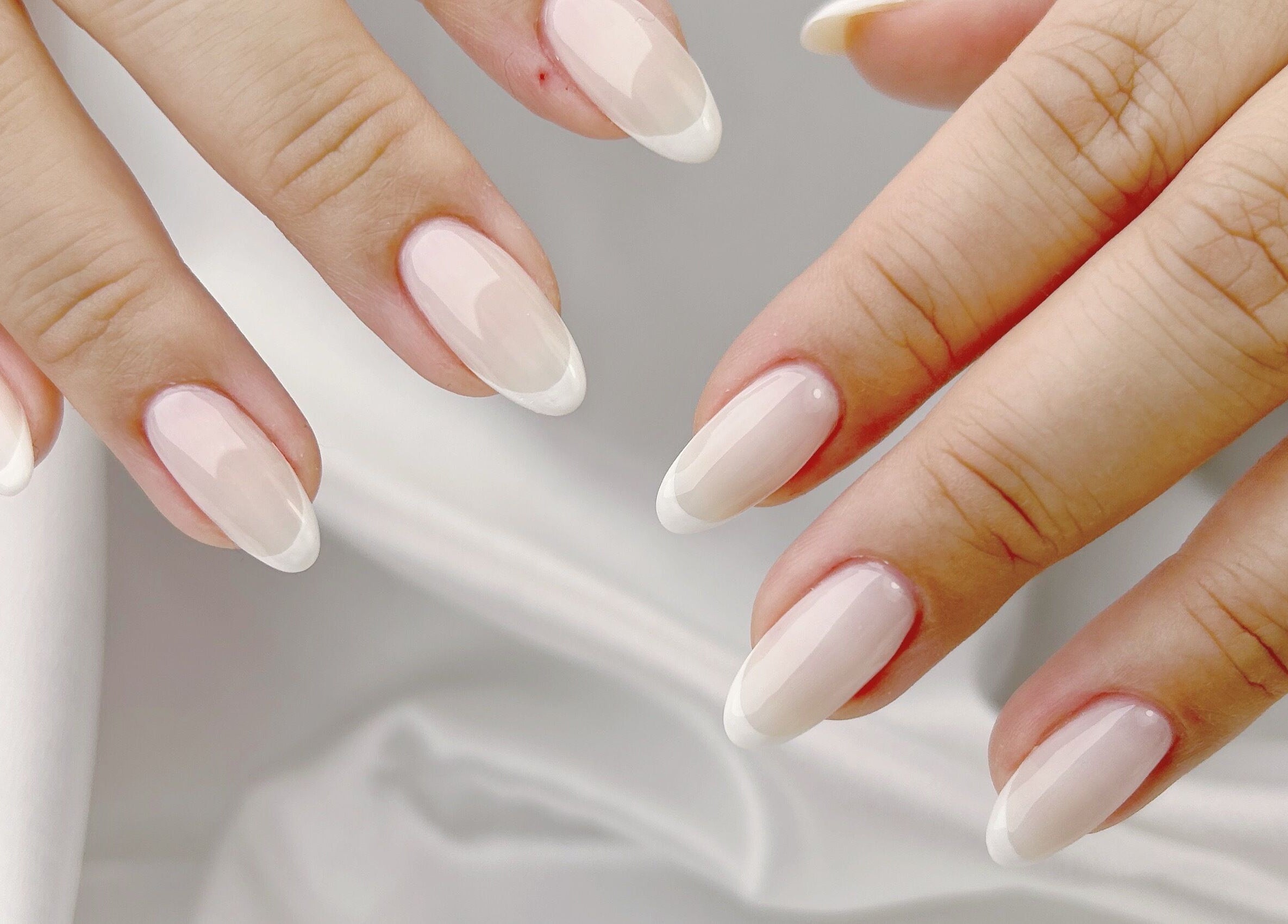 Close-up of elegant French manicure from Nail Room, 香港島, 香港島, HK, showcasing glossy nail art.