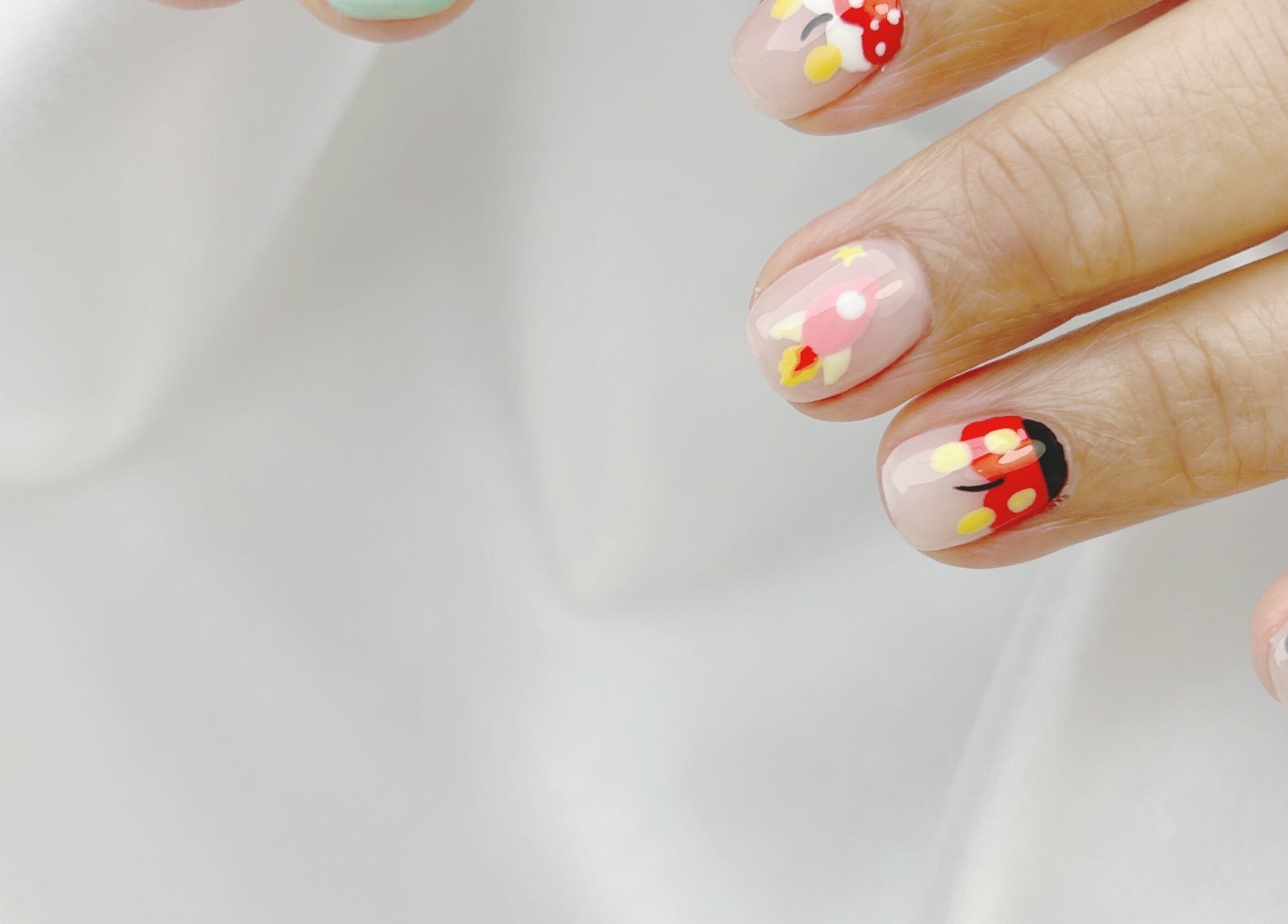 Close-up of vibrant nail designs at Nail Room, 香港島, 香港島, HK. Features colorful patterns.