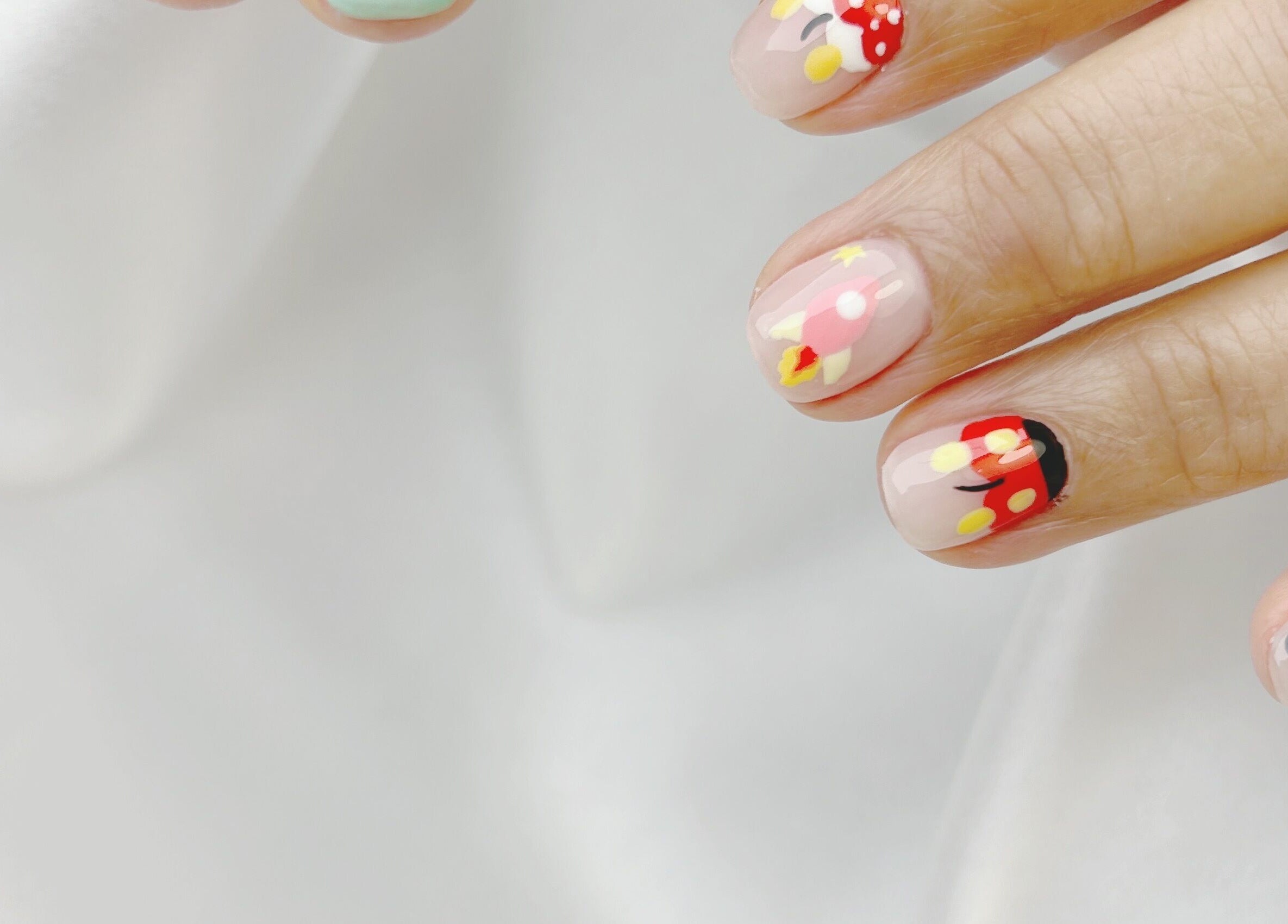 Close-up of vibrant nail designs at Nail Room, 香港島, 香港島, HK. Features colorful patterns.
