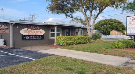 Front view of a spa at The Muscle Whisperer, New Port Richey, Florida, US with welcoming greenery.