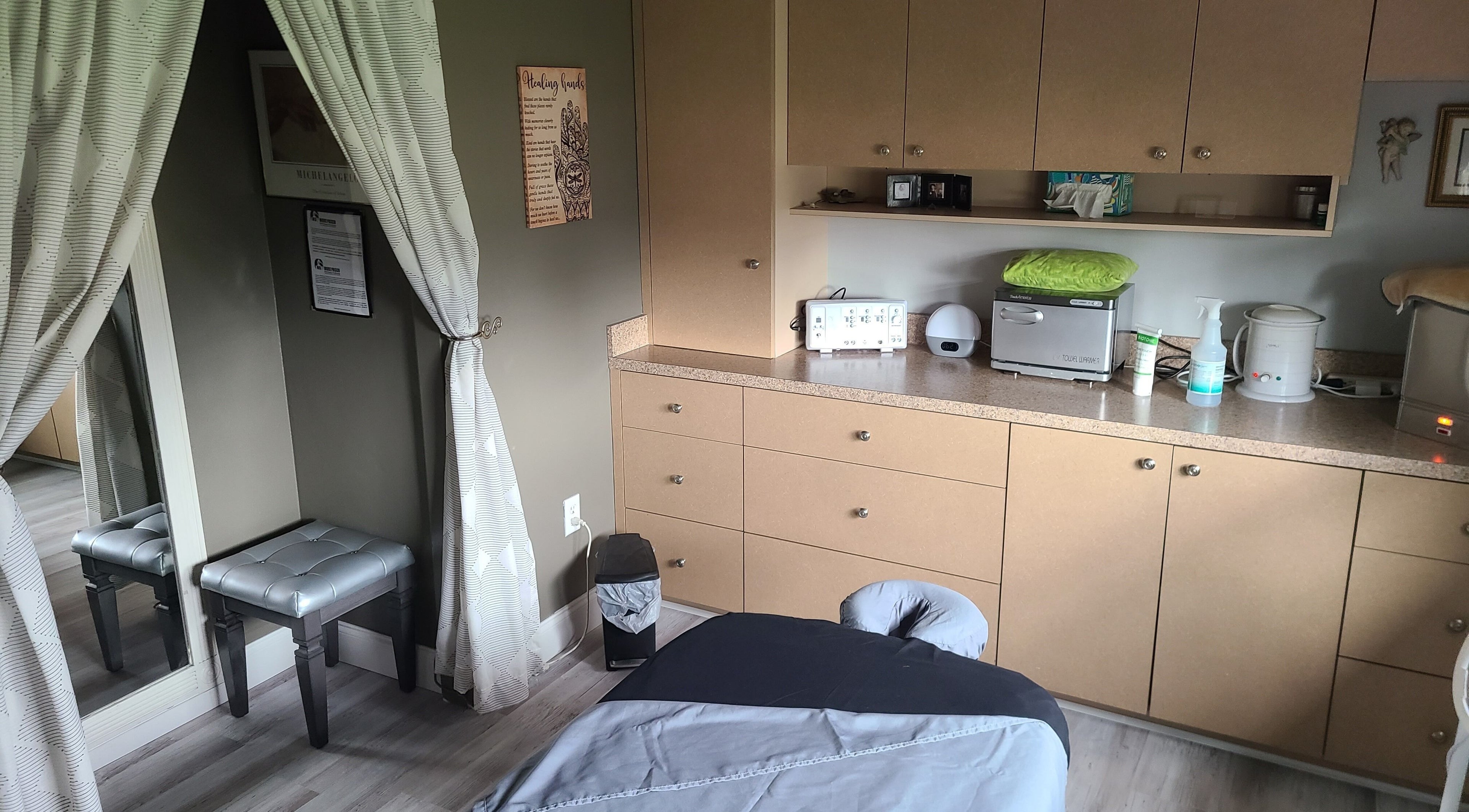 Calming massage room at The Muscle Whisperer, New Port Richey, Florida, US, featuring a cozy bed and soothing decor.