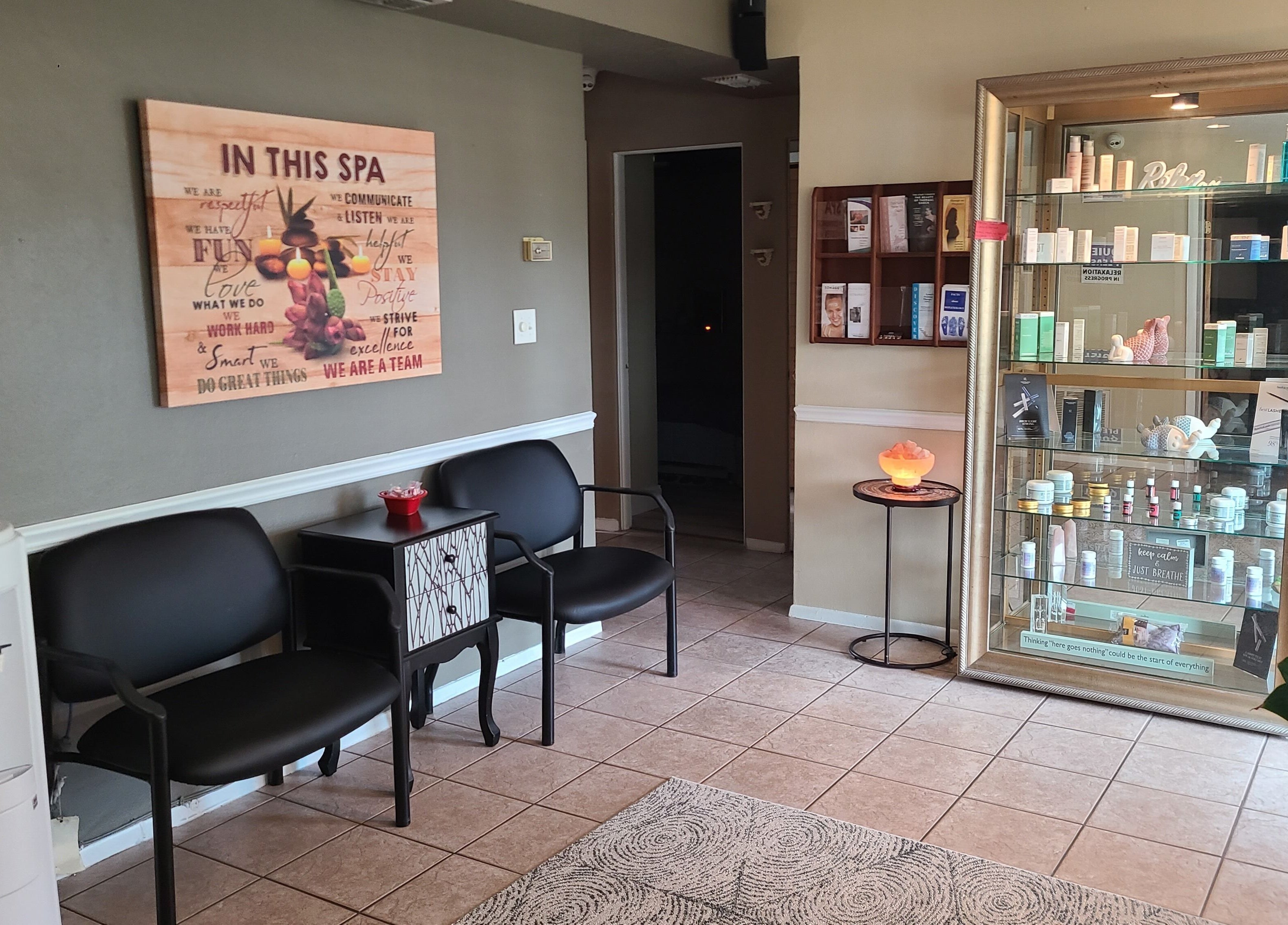 Cozy waiting area at The Muscle Whisperer in New Port Richey, Florida, US, featuring chairs and a display cabinet.