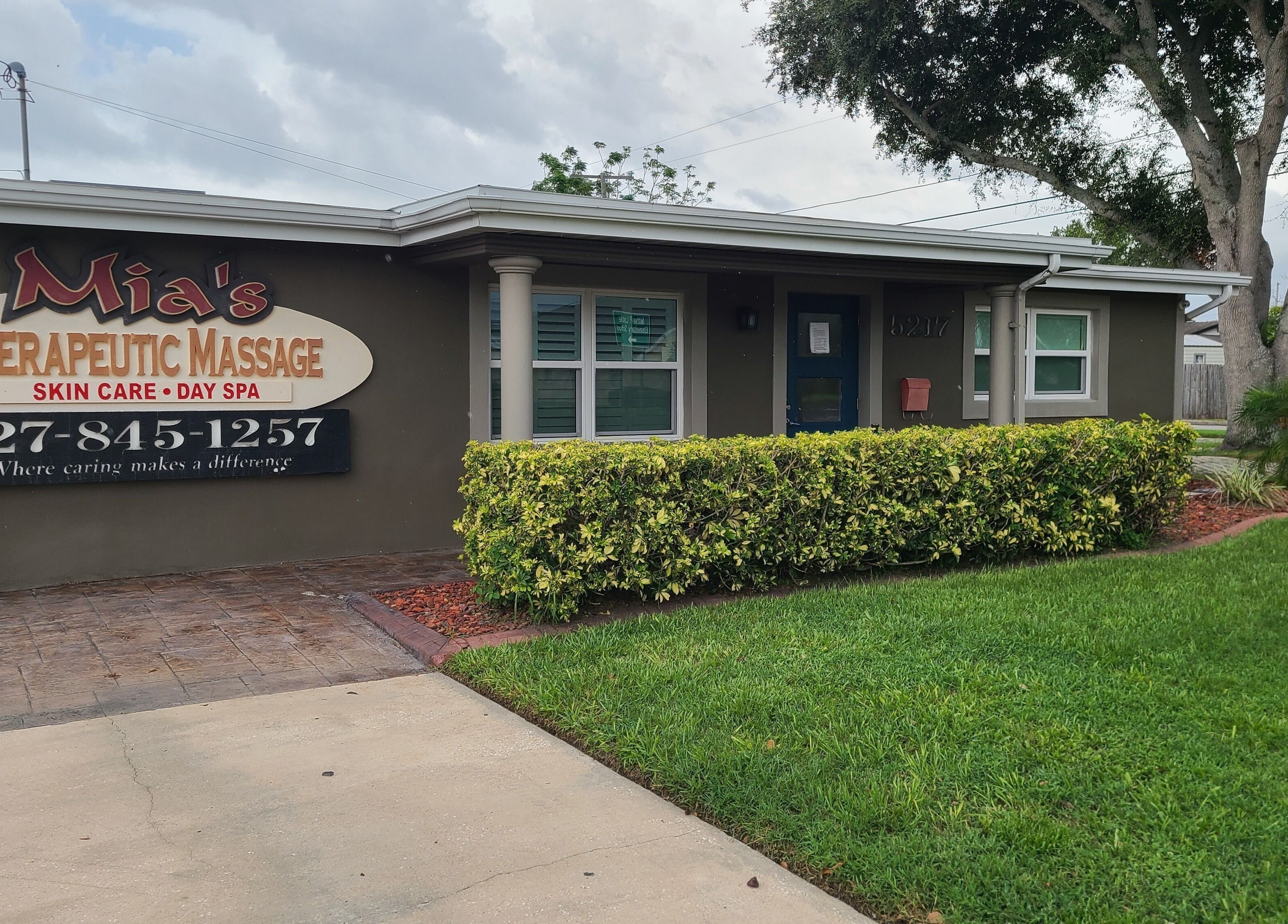 Exterior of The Muscle Whisperer in New Port Richey, Florida, US showcasing lush greenery and welcoming entrance.