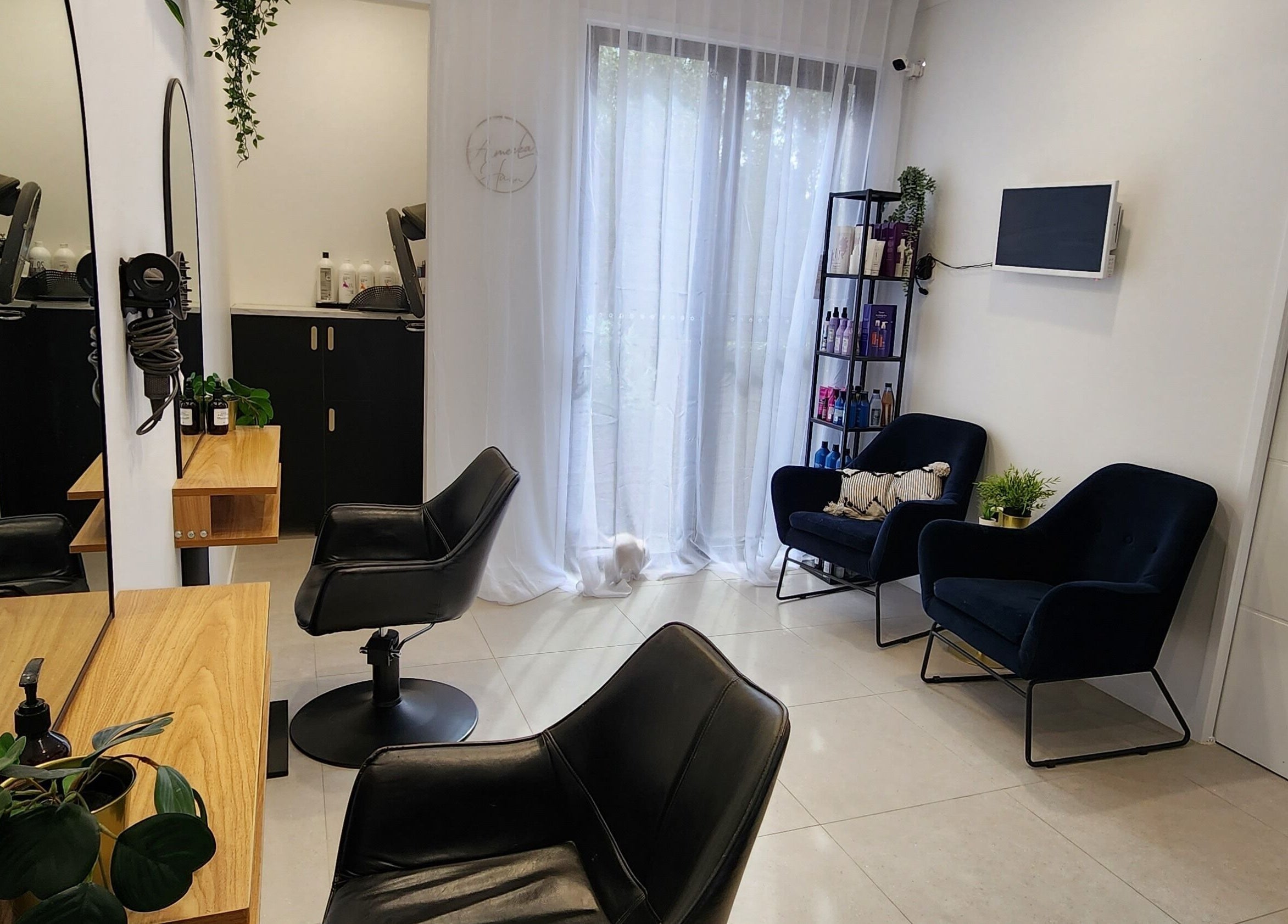Elegant interior of AimeeLea Hairdressing in Cornubia, Queensland, AU with stylish chairs and natural light.