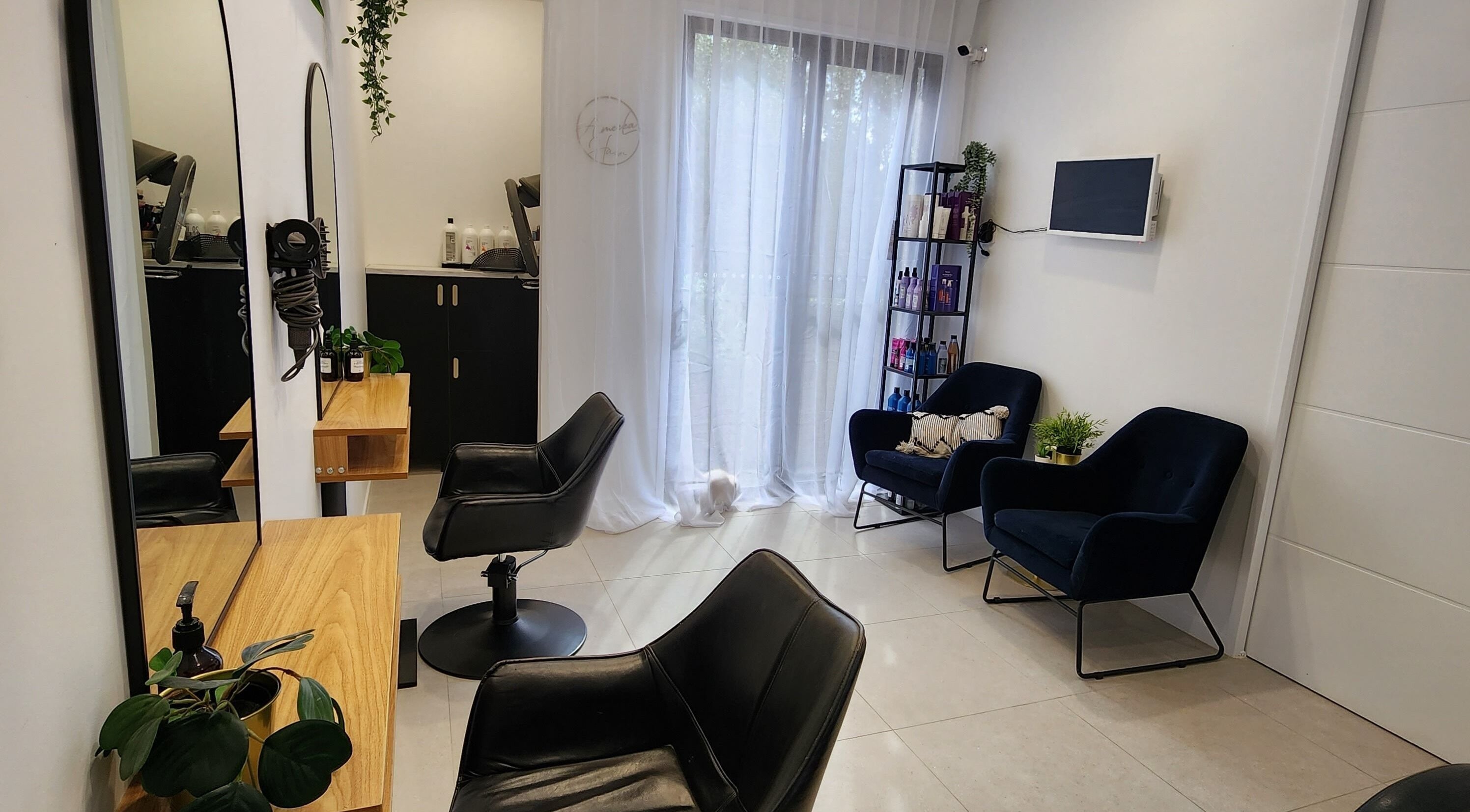 Elegant interior of AimeeLea Hairdressing in Cornubia, Queensland, AU with stylish chairs and natural light.
