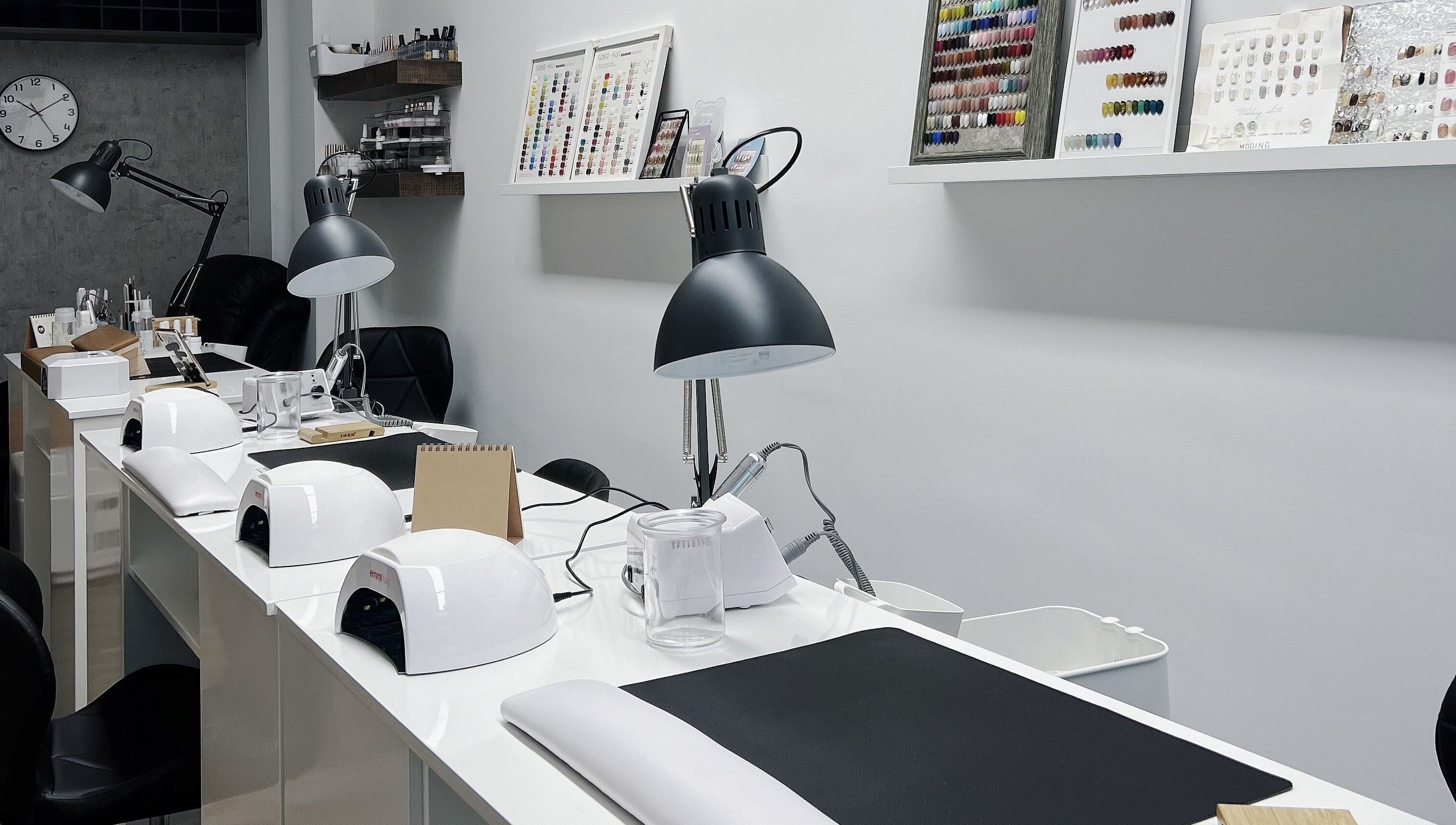 Modern nail salon workspace at F-Studio, Frankfurt Am Main, Hessen, DE. Sleek lamps and tools organized neatly.