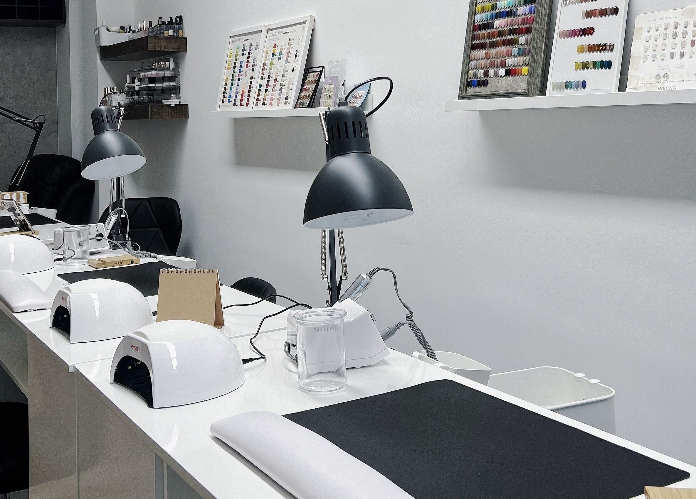 Modern nail salon workspace at F-Studio, Frankfurt Am Main, Hessen, DE. Sleek lamps and tools organized neatly.