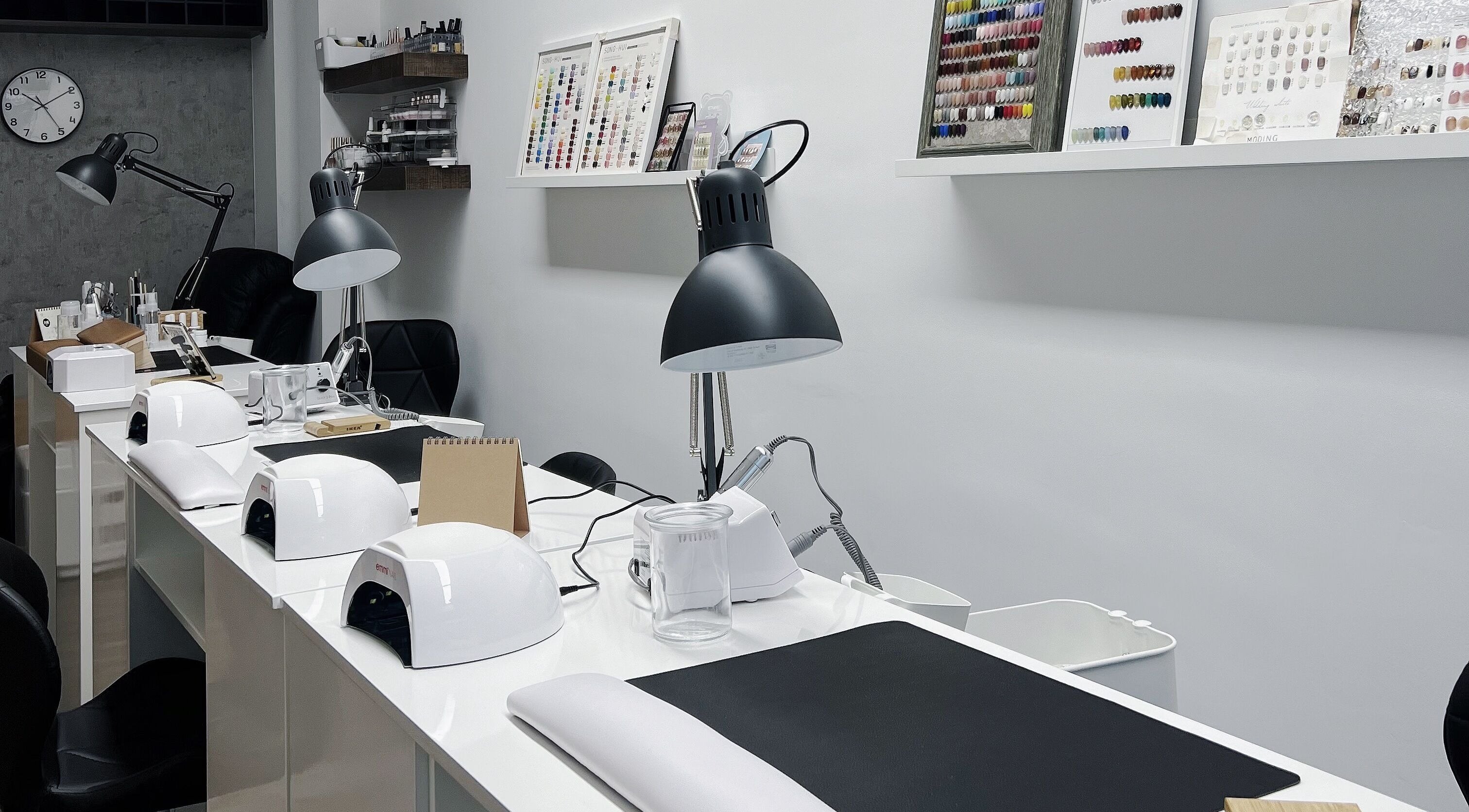 Modern nail salon workspace at F-Studio, Frankfurt Am Main, Hessen, DE. Sleek lamps and tools organized neatly.