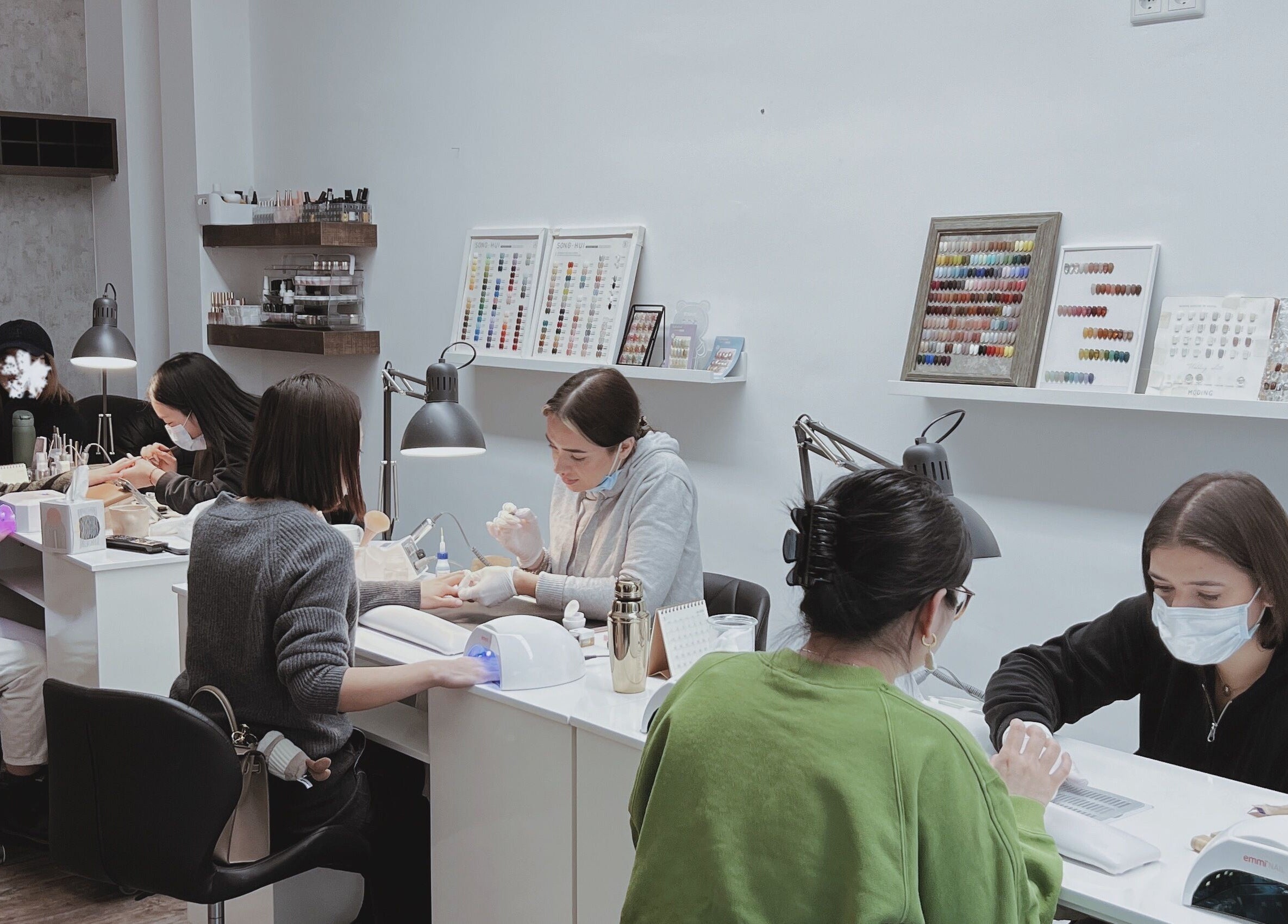F-Studio nail technicians at work, creating intricate designs in Frankfurt Am Main, Hessen, DE.