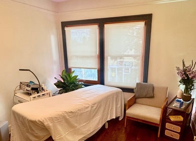 Tranquil treatment room at Reveal Electrolysis-Wallingford in Seattle, Washington, US, featuring a comfortable bed.