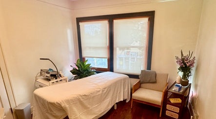 Tranquil treatment room at Reveal Electrolysis-Wallingford in Seattle, Washington, US, featuring a comfortable bed.