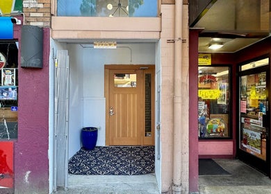 Entrance of Reveal Electrolysis-Wallingford at 11754, Seattle, Washington, US surrounded by vibrant shops.