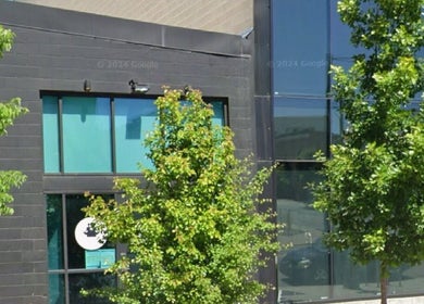 Front view of TEAspot: Denver at Denver, Colorado, US, with modern architecture and green trees.