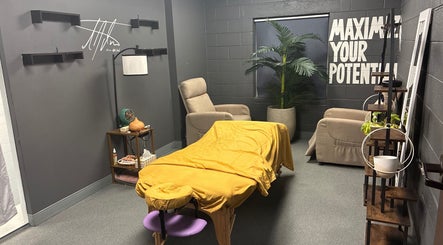 Relaxing massage room at TEASpot: Denver Five Points, Denver, Colorado, US with cozy chairs and plants.