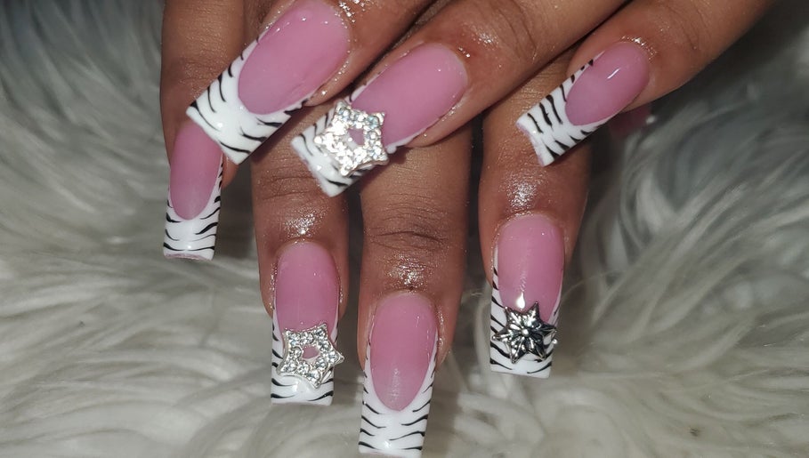 Stylish zebra-striped nails with rhinestones at Sheika's Artistic Designs, Wakefield, Trelawny Parish, JM.