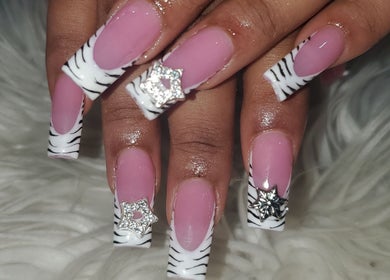 Stylish zebra-striped nails with rhinestones at Sheika's Artistic Designs, Wakefield, Trelawny Parish, JM.