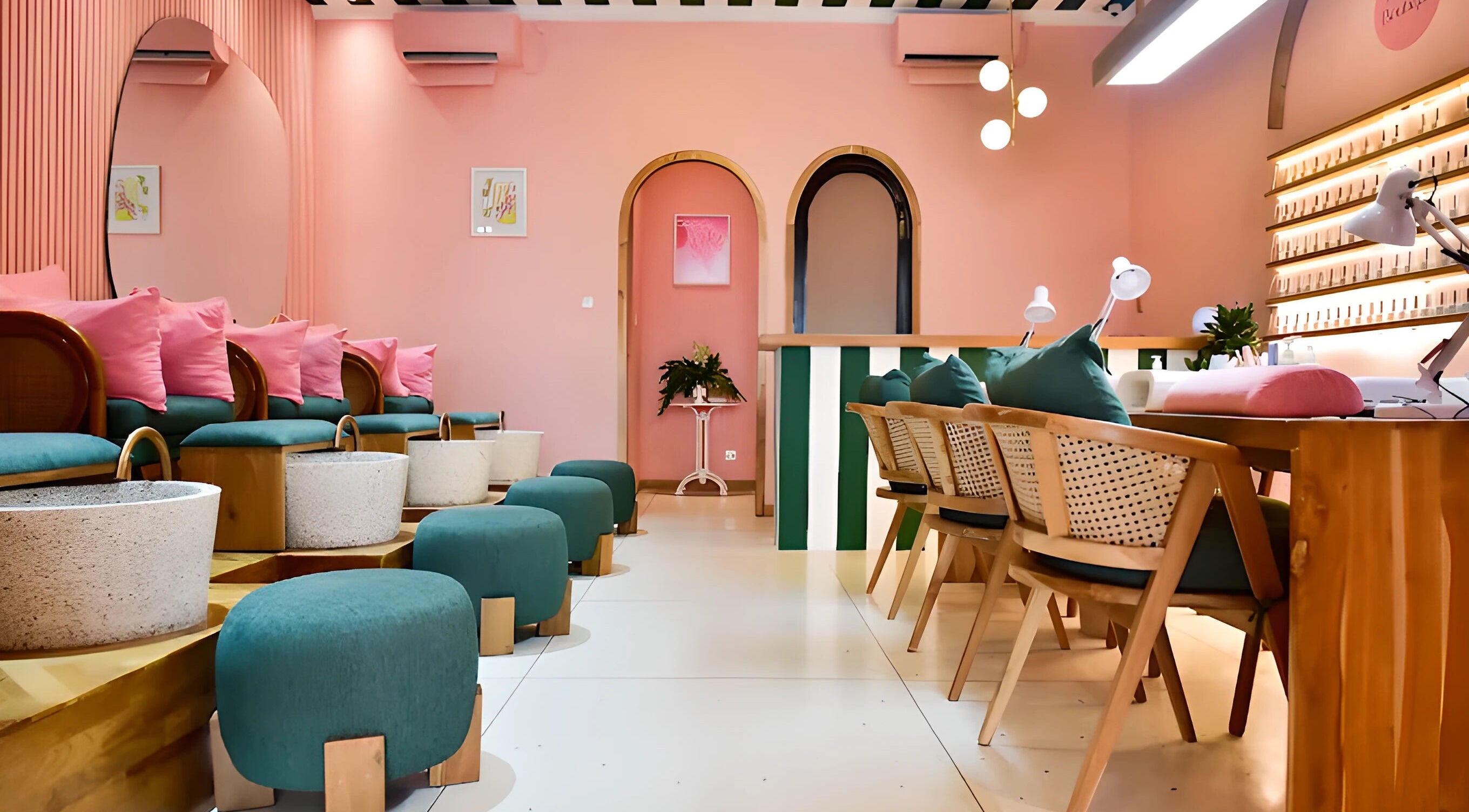 Trendy interior of The Nail Boutique in Bali, Bali, ID with pink walls and cozy seating.