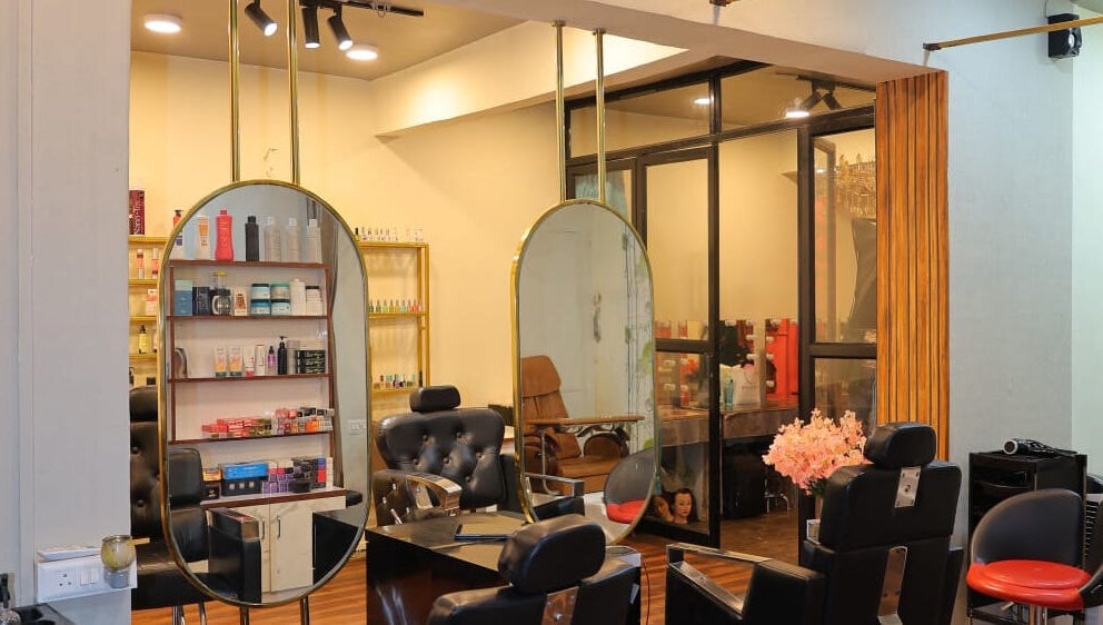 Modern interior of Naturā Unisex Salon in Pune, Maharashtra, IN with stylish chairs and mirrors.