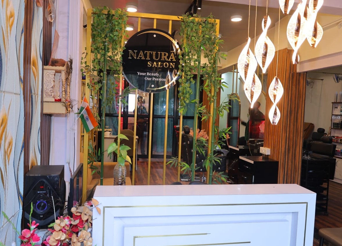Reception with plants and modern lighting at Naturā Unisex Salon, Pune, Maharashtra, IN.