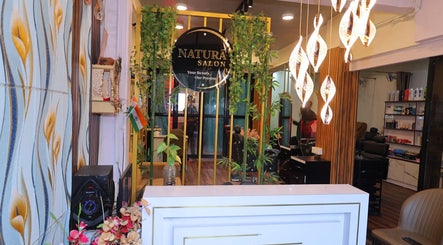 Reception with plants and modern lighting at Naturā Unisex Salon, Pune, Maharashtra, IN.