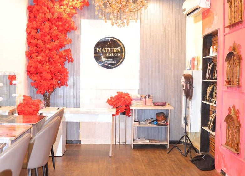 Elegant interior of Naturā Unisex Salon in Pune, Maharashtra, IN with vibrant decor and chic furniture.