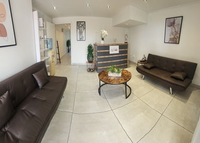 Stylish lounge at 50 Shades of Beauty and Slimming, Cape Town, Western Cape, ZA featuring chic sofas and decor.