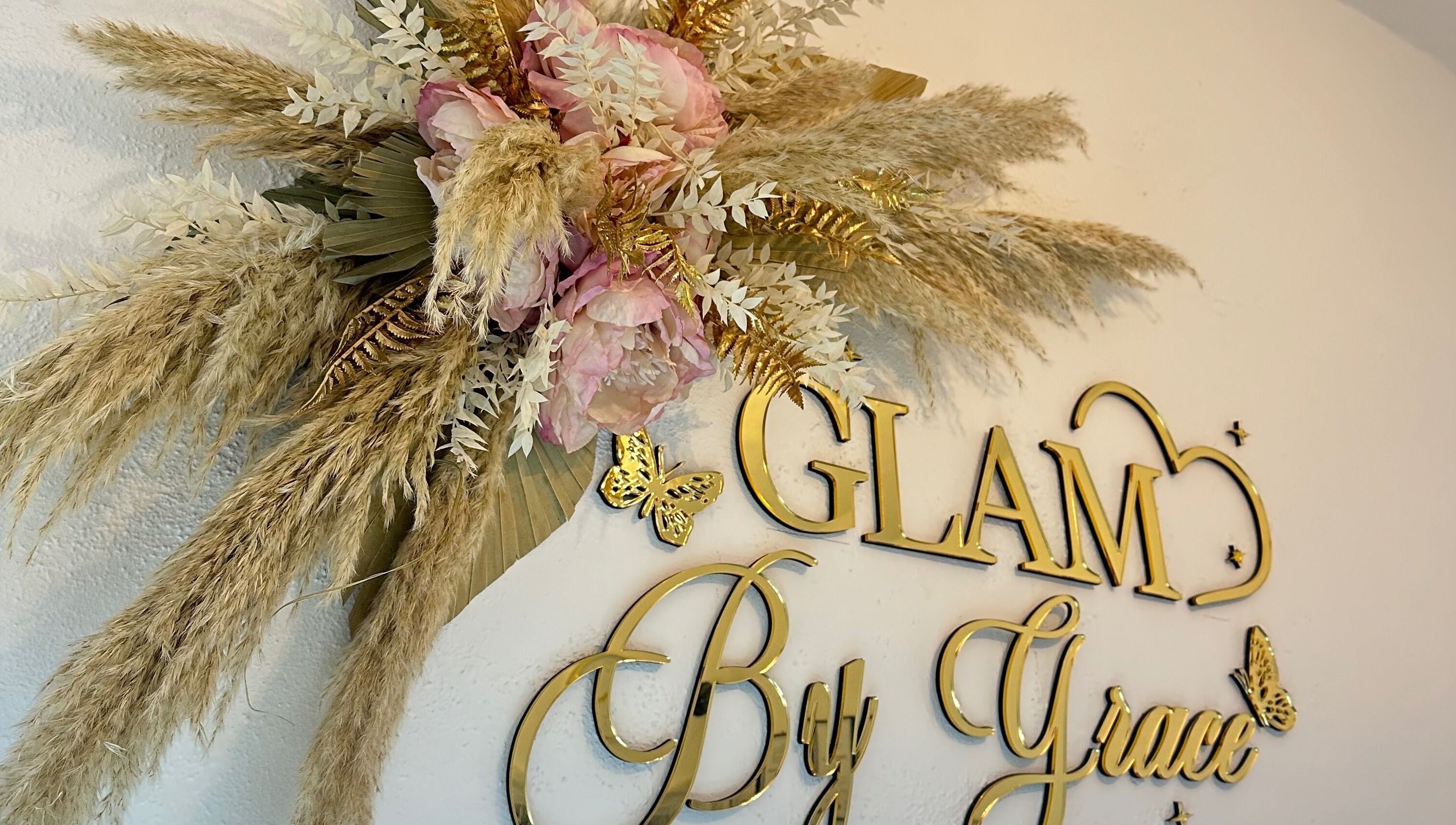 Elegant floral decor at Glam By Grace, Kings Langley, England, GB, showcasing gold lettering and delicate flowers.