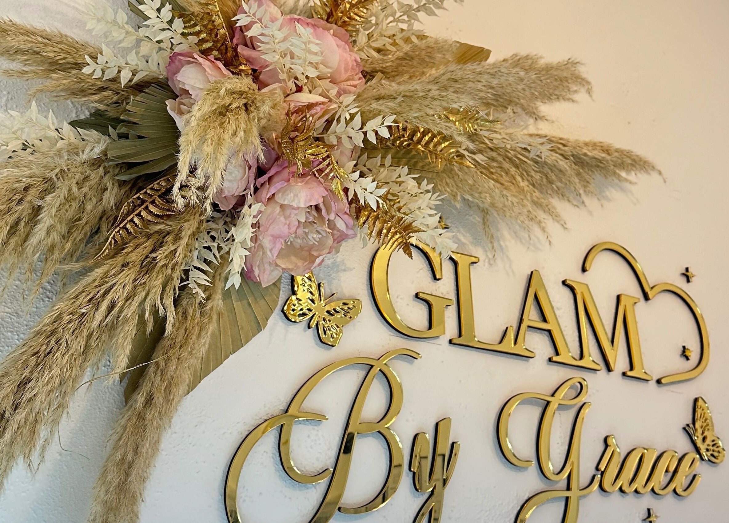 Elegant floral decor at Glam By Grace, Kings Langley, England, GB, showcasing gold lettering and delicate flowers.