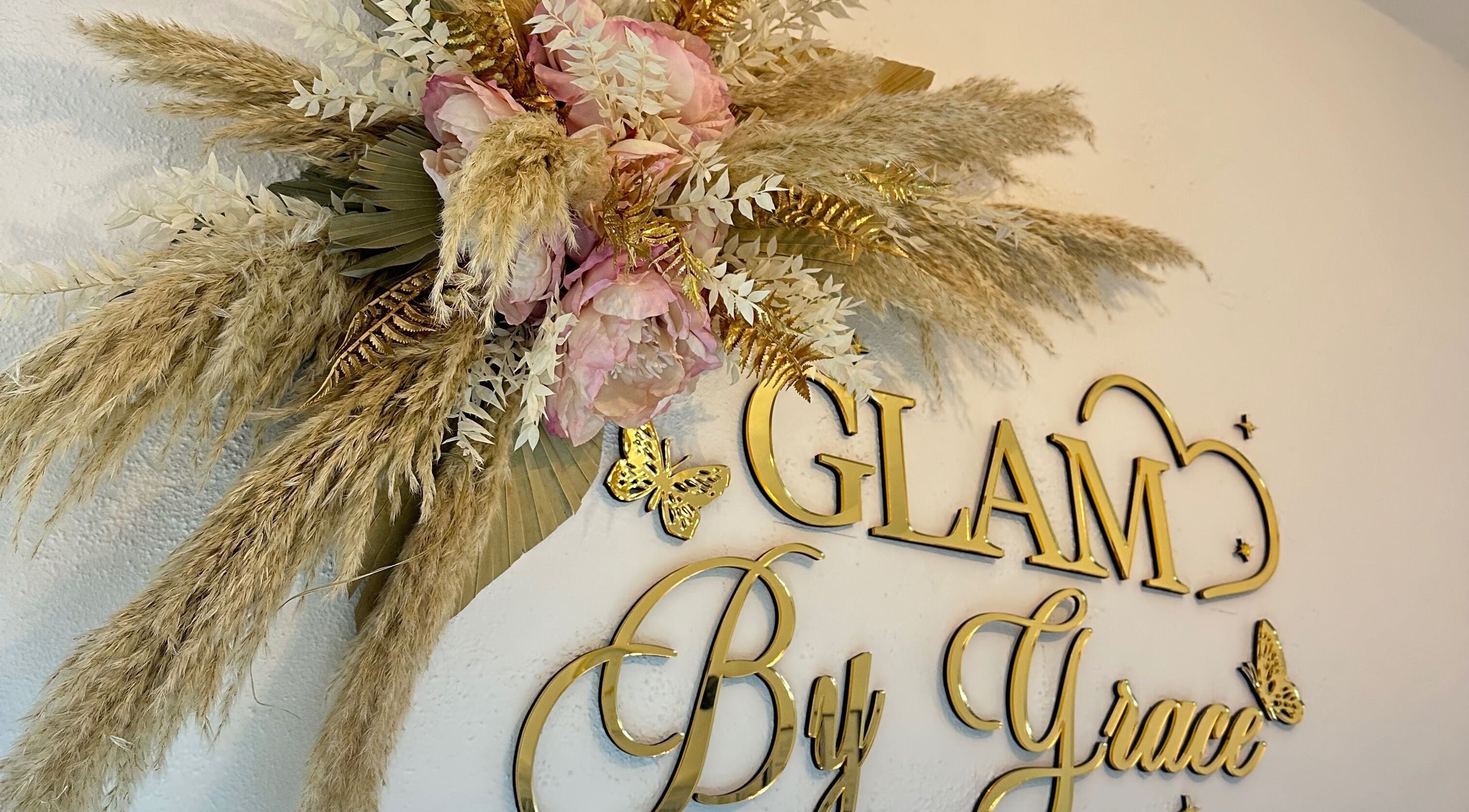 Elegant floral decor at Glam By Grace, Kings Langley, England, GB, showcasing gold lettering and delicate flowers.