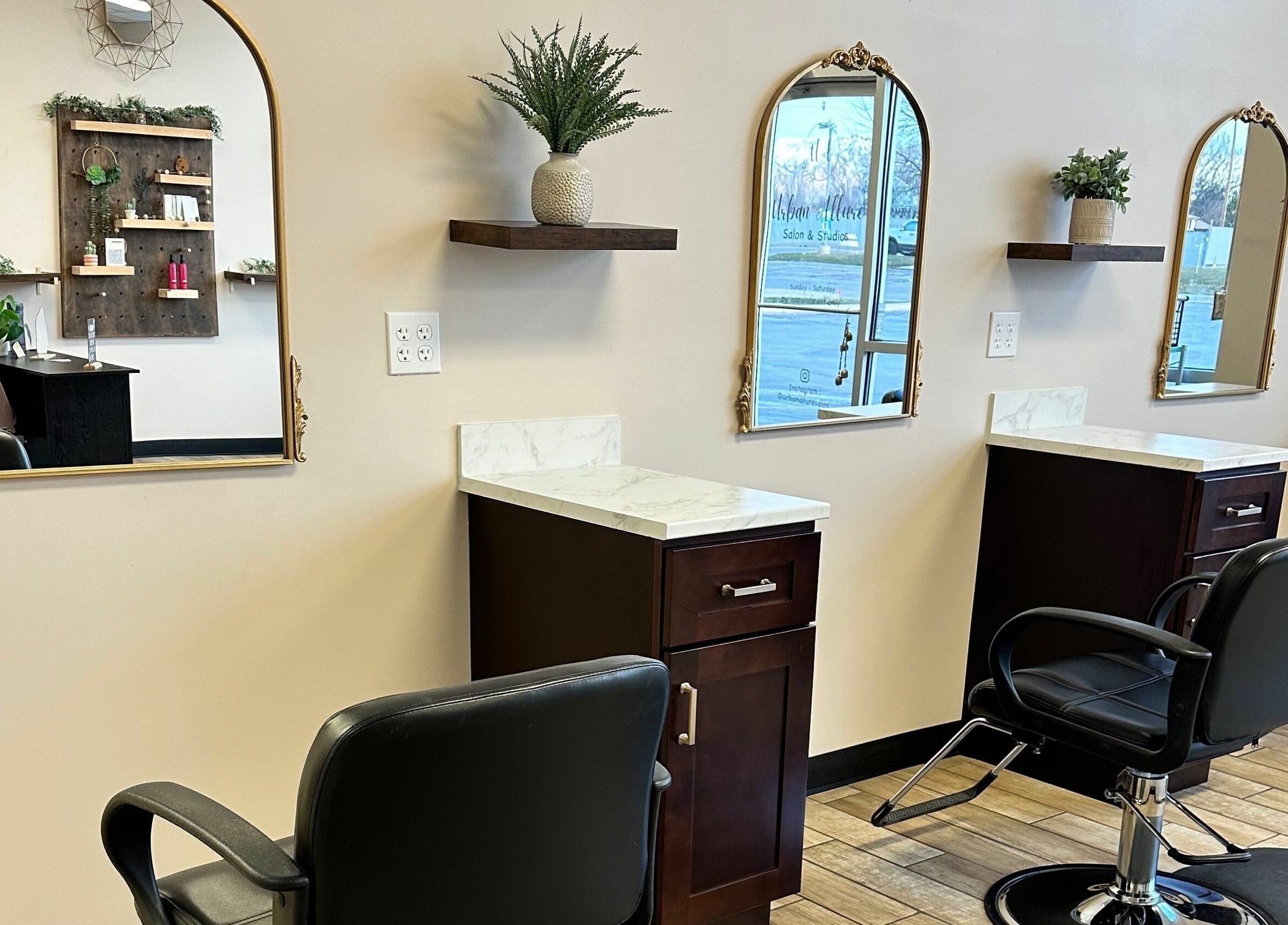 Elegant styling stations at Urban Allure Salon and Studios, Roy, Utah, US, showcasing sleek design and mirrors.