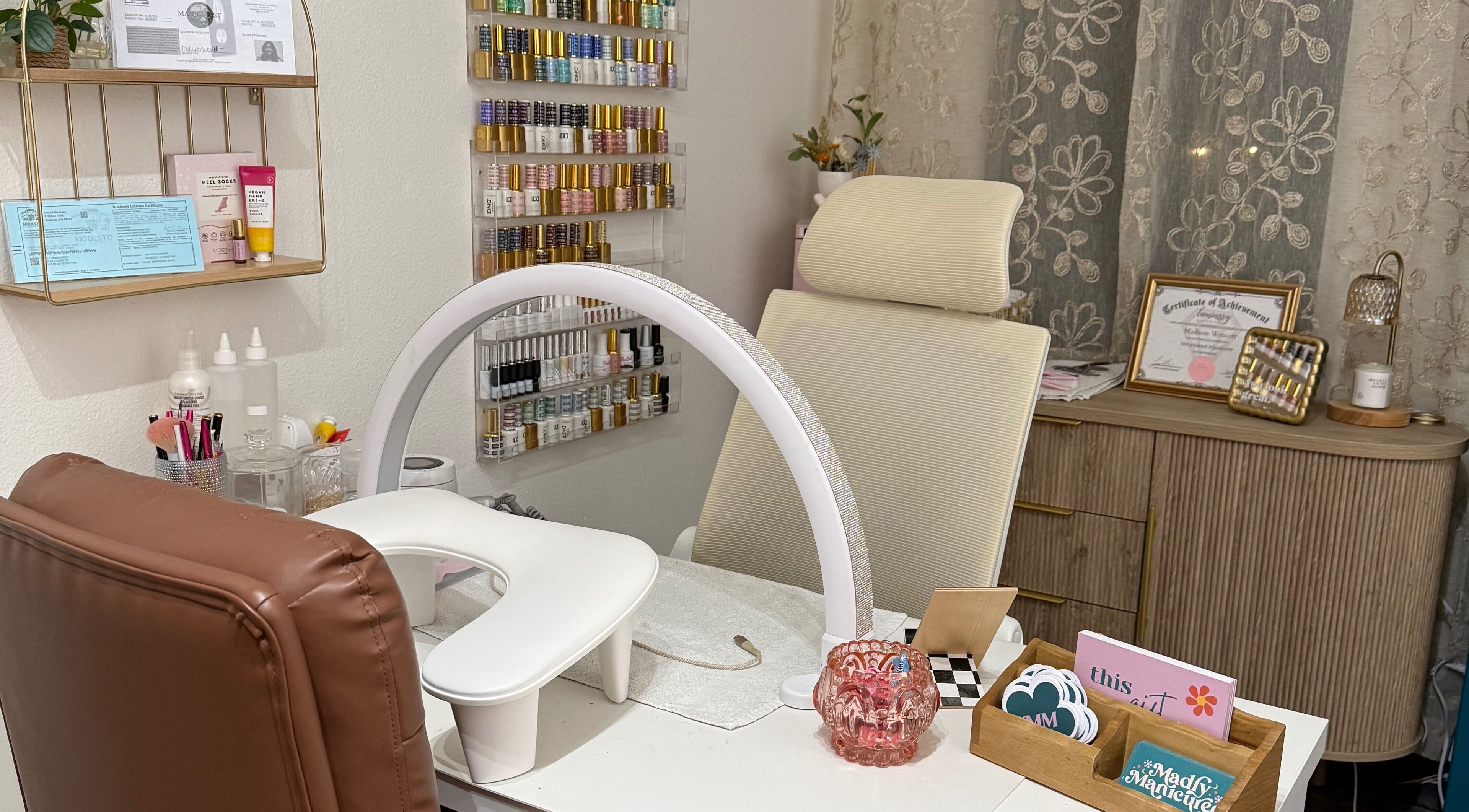 Manicure station at Madly Manicured, Modesto, California, US, featuring chic decor and nail polish selection.