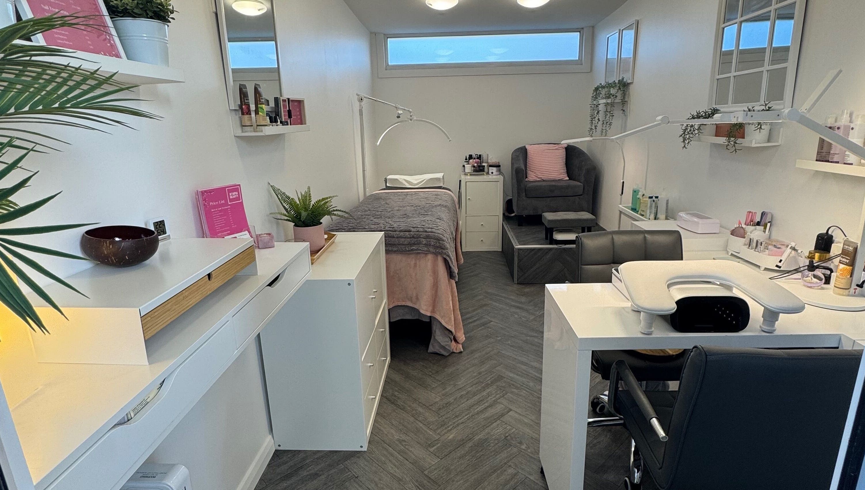 Relaxing treatment room at Utopia Beauty Farnham, Farnham, England, GB, featuring modern decor and amenities.